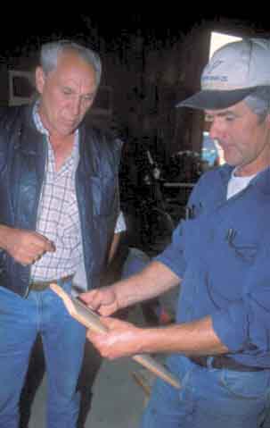 Tom Milne and Doug Rouck look at flooring.